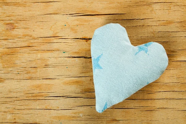 Heart from cloth on wood desk — Stock Photo, Image