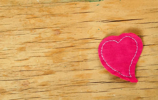 Heart from cloth on wood desk — Stock Photo, Image