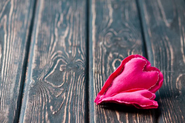 Heart from cloth on wood desk — Stock Photo, Image