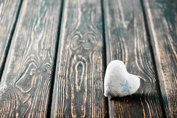 Heart from cloth on wood desk — Stock Photo, Image