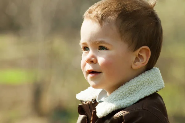 Child in a leather jacket outdoors — Stock Photo, Image