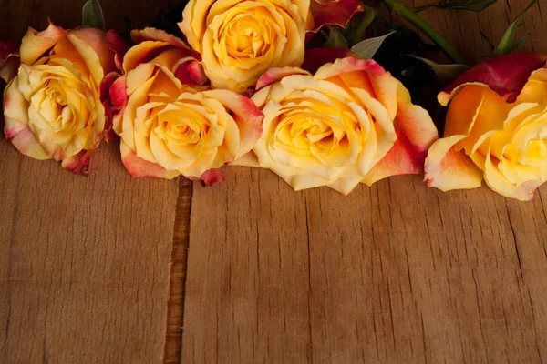 Fresh roses on wood desk