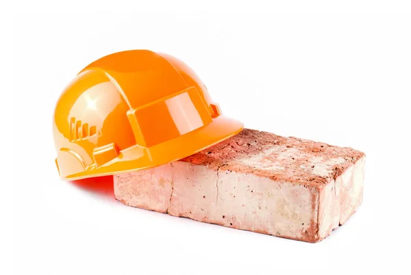 Іграшковий помаранчевий будівельний шолом ізольований на білому тлі — стокове фото