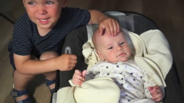 Das Baby spielt mit dem Kind — Stockvideo