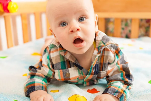 Smile baby with toy on bad — Stock Photo, Image