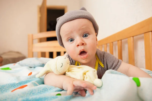 Smile baby with toy on bad — Stock Photo, Image