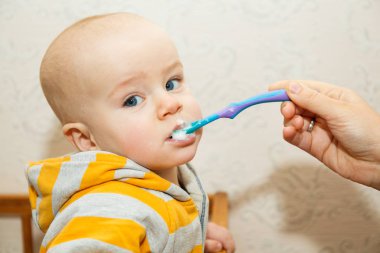 Çocuk bir kaşıkla püresi yiyor