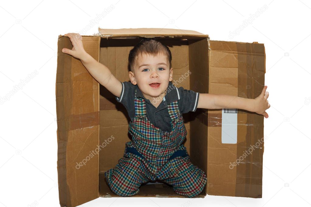 Little boy in paper box