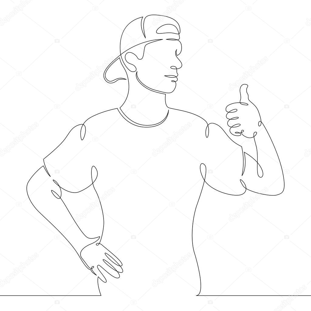young man in a baseball cap shows thumb up