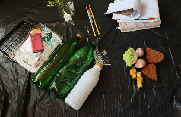 Large heap of garbage inside a processing plant. black background