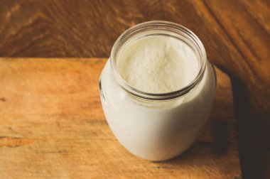 Ahşap bir gemide bir cam kap içinde ekşi süt