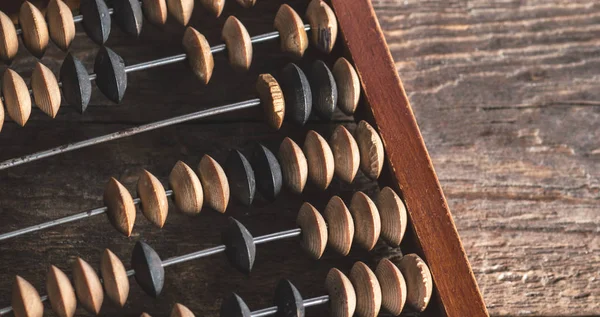 Vintage abacus on an wooden background photo — Stock Photo, Image