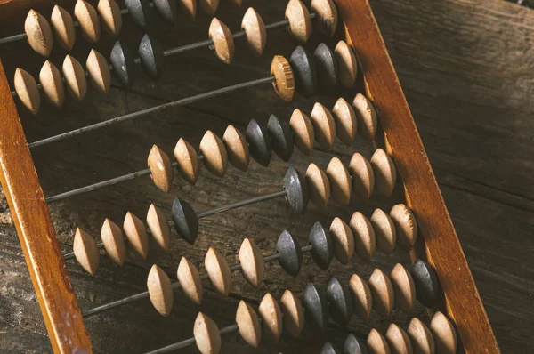 Vintage abacus on an wooden background photo — Stock Photo, Image