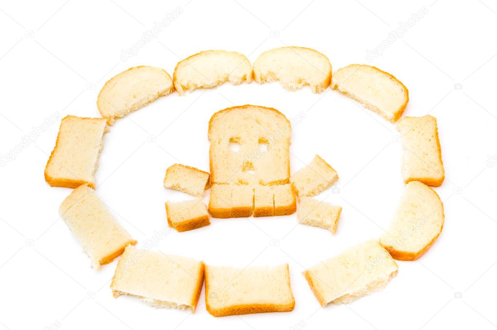 Skull and bones made of sliced bread isolated on white background