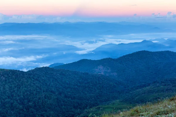 Early morning foggy  sunrise on  top of mountain soft focus grai — Stock Photo, Image