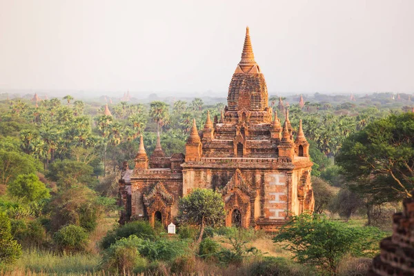 Salida del sol con antiguo templo y paisaje verde, Bagan, Myanmar — Foto de Stock