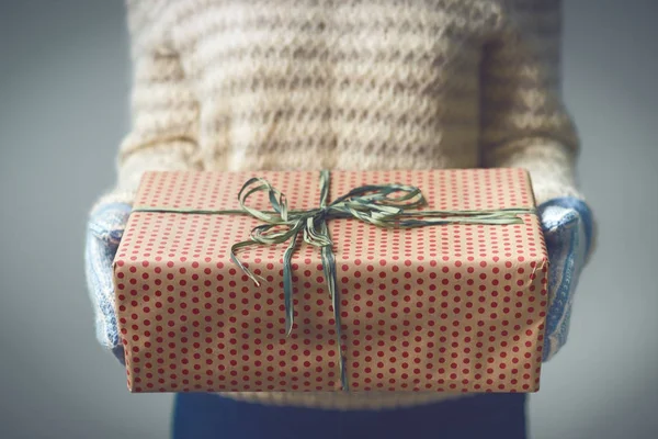 Uma menina segurando uma caixa com um presente de Natal — Fotografia de Stock