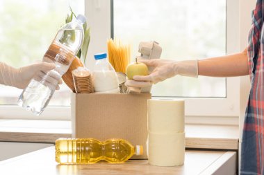 İçi açık yiyecek dolu bir bağış kutusu. Covid-19 salgını sırasında yemek teslimatı, koronavirüs. Uzayı kopyala Yemek Teslimatı Konsepti. Metin için boşluk.