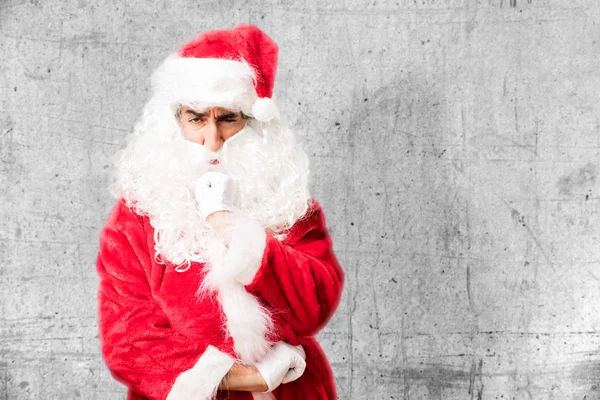 Santa claus in oneens pose — Stockfoto