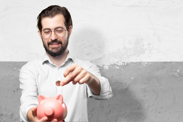 Happy young man piggy bank — Stock Photo, Image