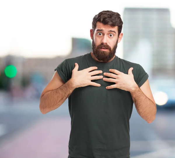 Surprised young man in confused pose — Stock Photo, Image