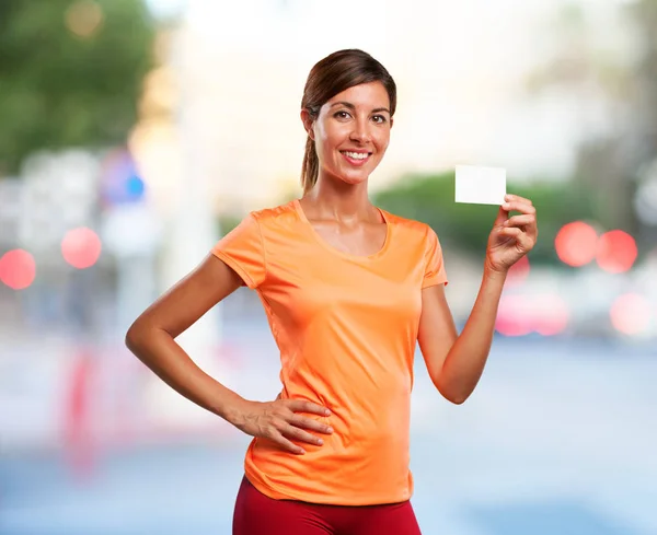 Strong sport woman with visit card — Stock Photo, Image