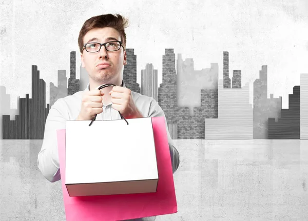 Boring young man with shopping bags — Stock Photo, Image