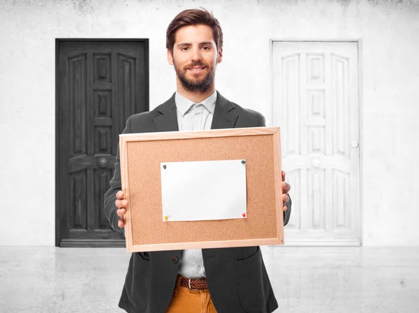 Happy businessman with corkboard note — Stock Photo, Image