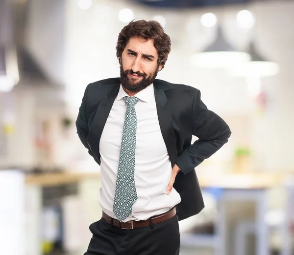 Happy businessman with backache — Stock Photo, Image