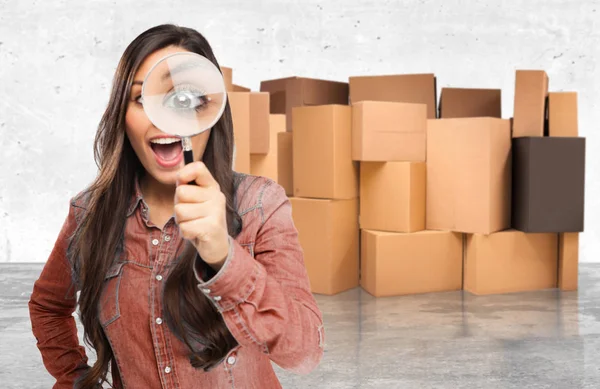 Happy young woman with magnifying glass — Stock Photo, Image