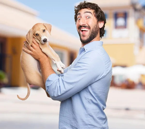 Happy young man with puppy — Stock Photo, Image