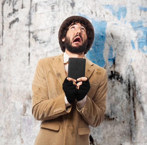 Happy homeless man with bible — Stock Photo, Image