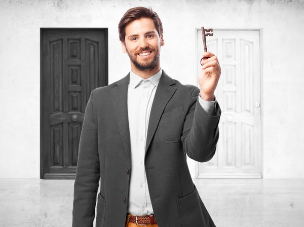 Happy businessman with vintage key — Stock Photo, Image