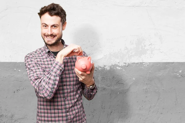 Glücklicher junger Mann mit Sparschwein — Stockfoto