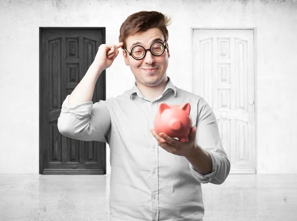 Crazy young man with piggy bank — Stock Photo, Image