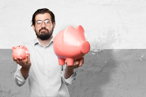 Confused young man with piggy banks — Stock Photo, Image