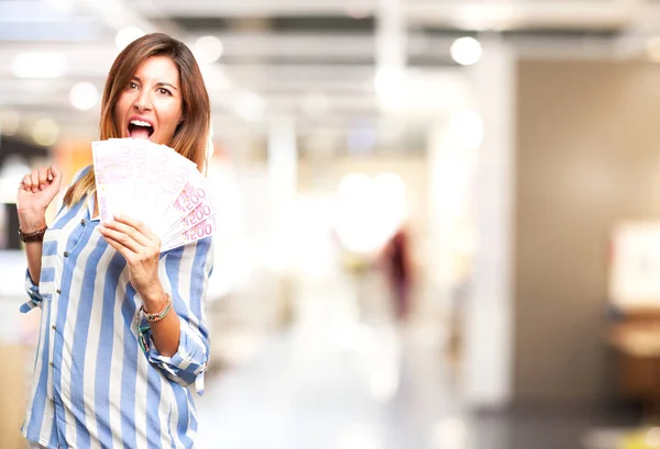 Happy young woman with bills — Stock Photo, Image