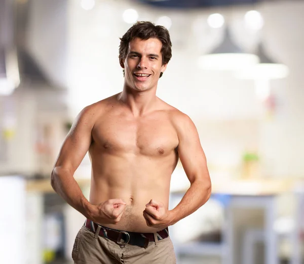 Strong young man in proud pose — Stock Photo, Image