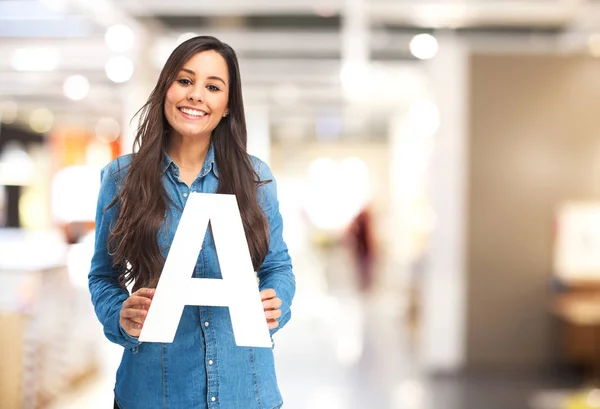 Happy young woman with letter a — Stock Photo, Image