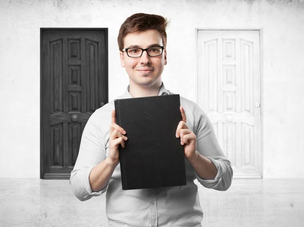 Happy young man with small book — Stock Photo, Image