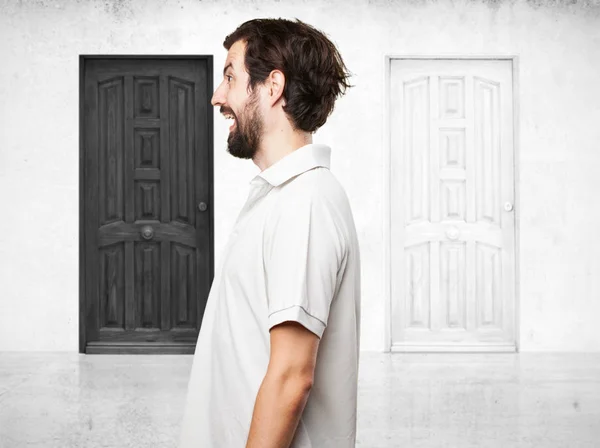 Young man near two doors — Stock Photo, Image