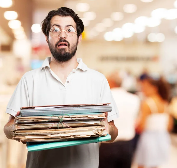 Stressed young man with files — Stock Photo, Image