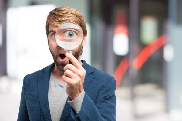 Happy businessman with magnifying glass — Stock Photo, Image
