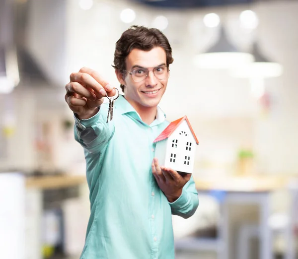 Man with house model and key — Stock Photo, Image