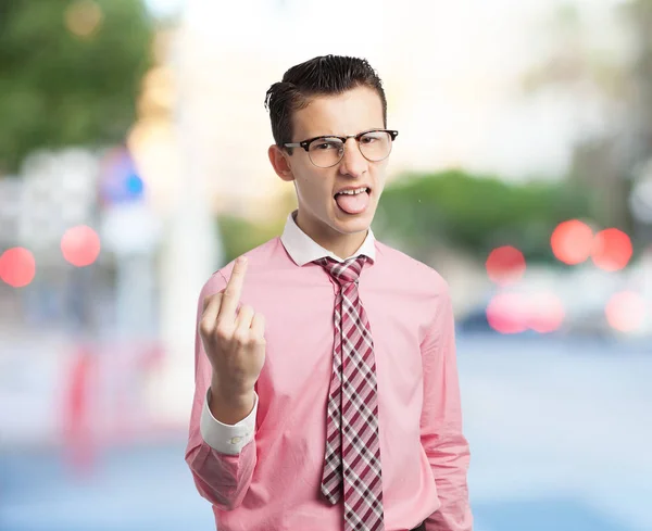 Angry young man in oneens pose — Stockfoto