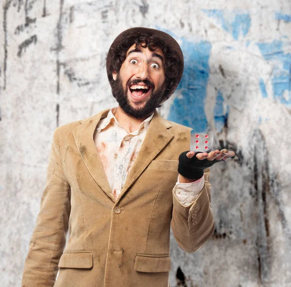 Happy homeless man with dice — Stock Photo, Image