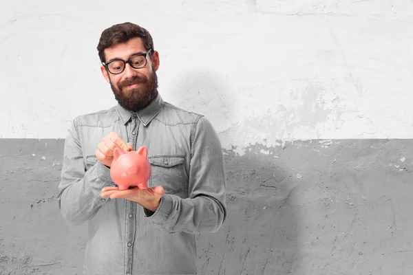 Glücklicher junger Mann mit Sparschwein — Stockfoto