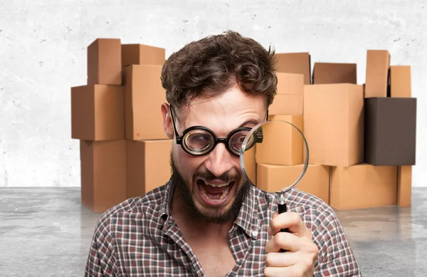 Crazy young man with magnifying glass — Stock Photo, Image