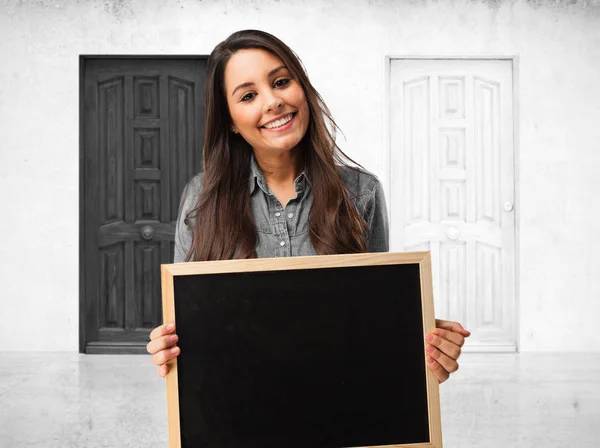 Happy young woman with blackboard — Stock Photo, Image