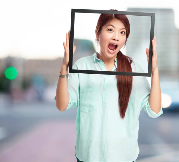 Happy chinese woman with black frame — Stock Photo, Image